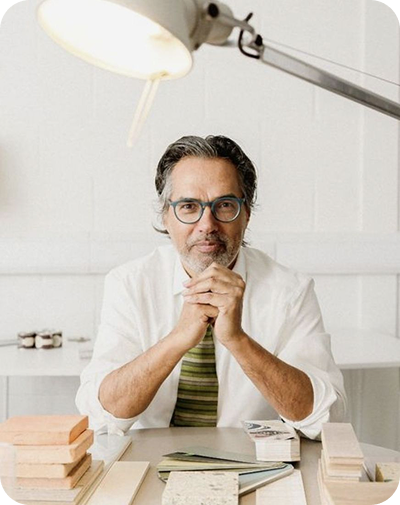 An Uprising Health physician at a desk in a bright consulting room